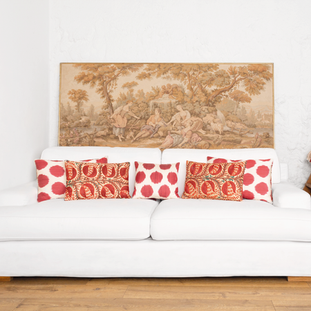 suzani, ikat and velvet cushions on white modern sofa